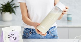 Shaking up Nimbus oat milk in bottle