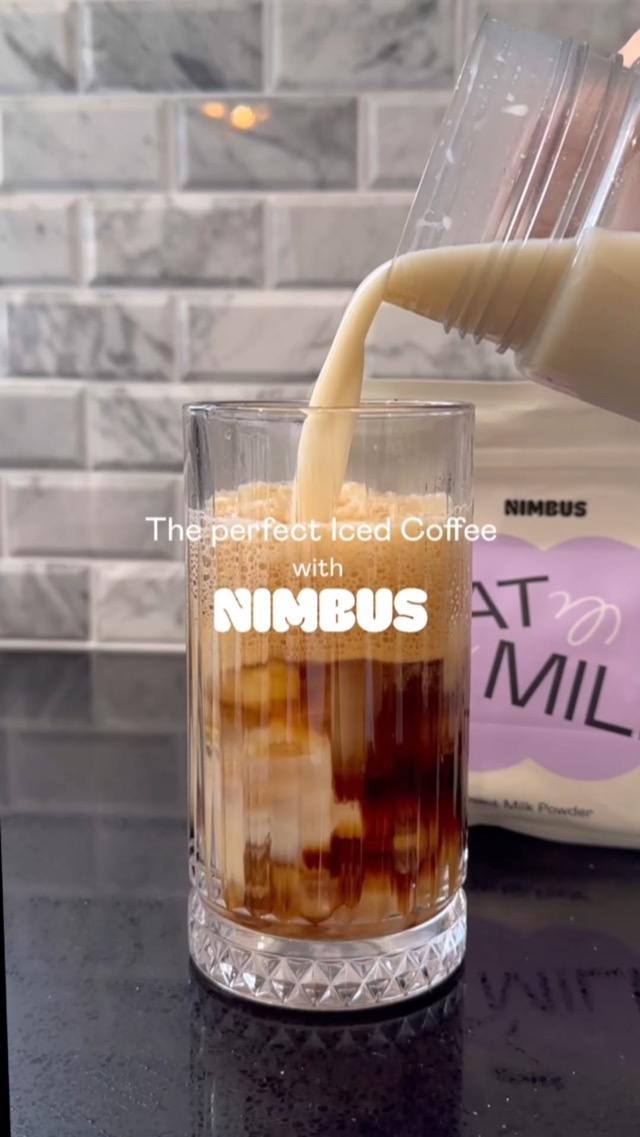 Nimbus oat milk being poured into foamy iced coffee