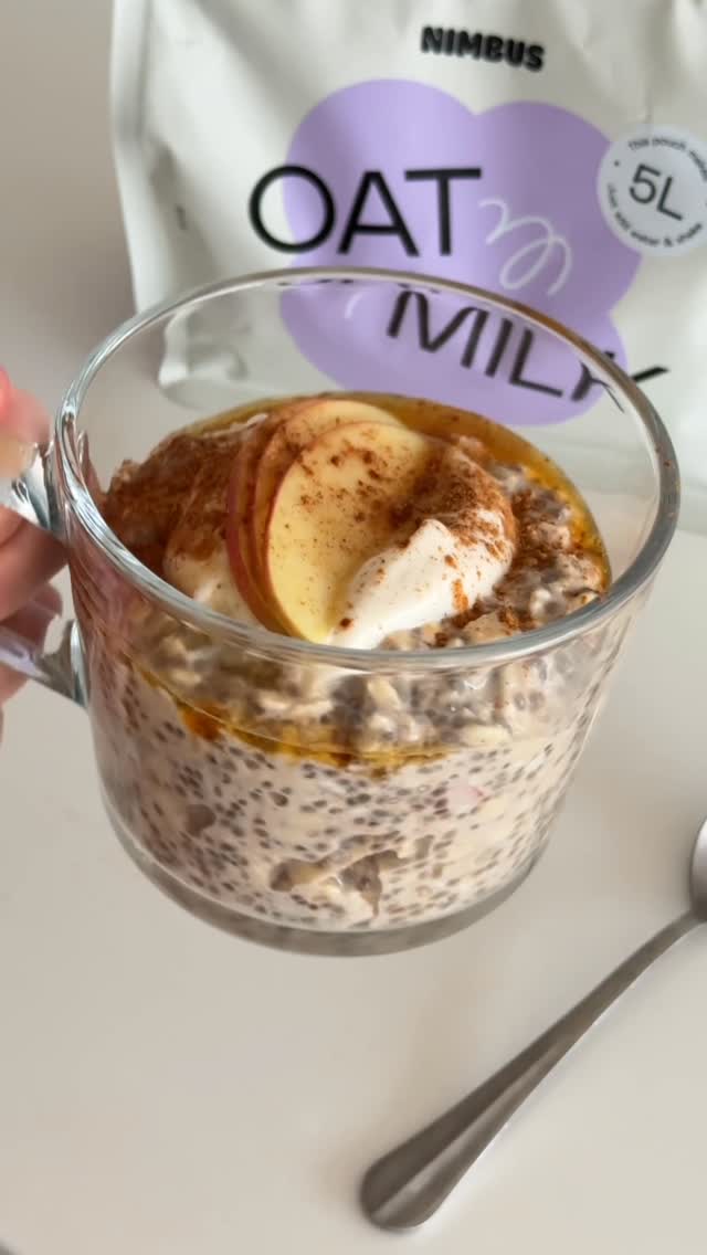 Apple pie overnight oats with yoghurt, apple and cinnamon beside Nimbus Oat Milk