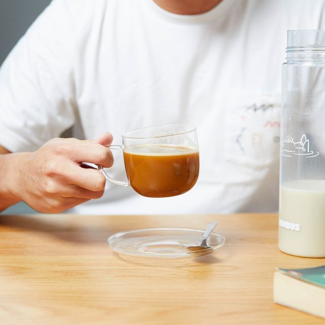 Oat coffee in a glass cup beside a Nimbus bottle